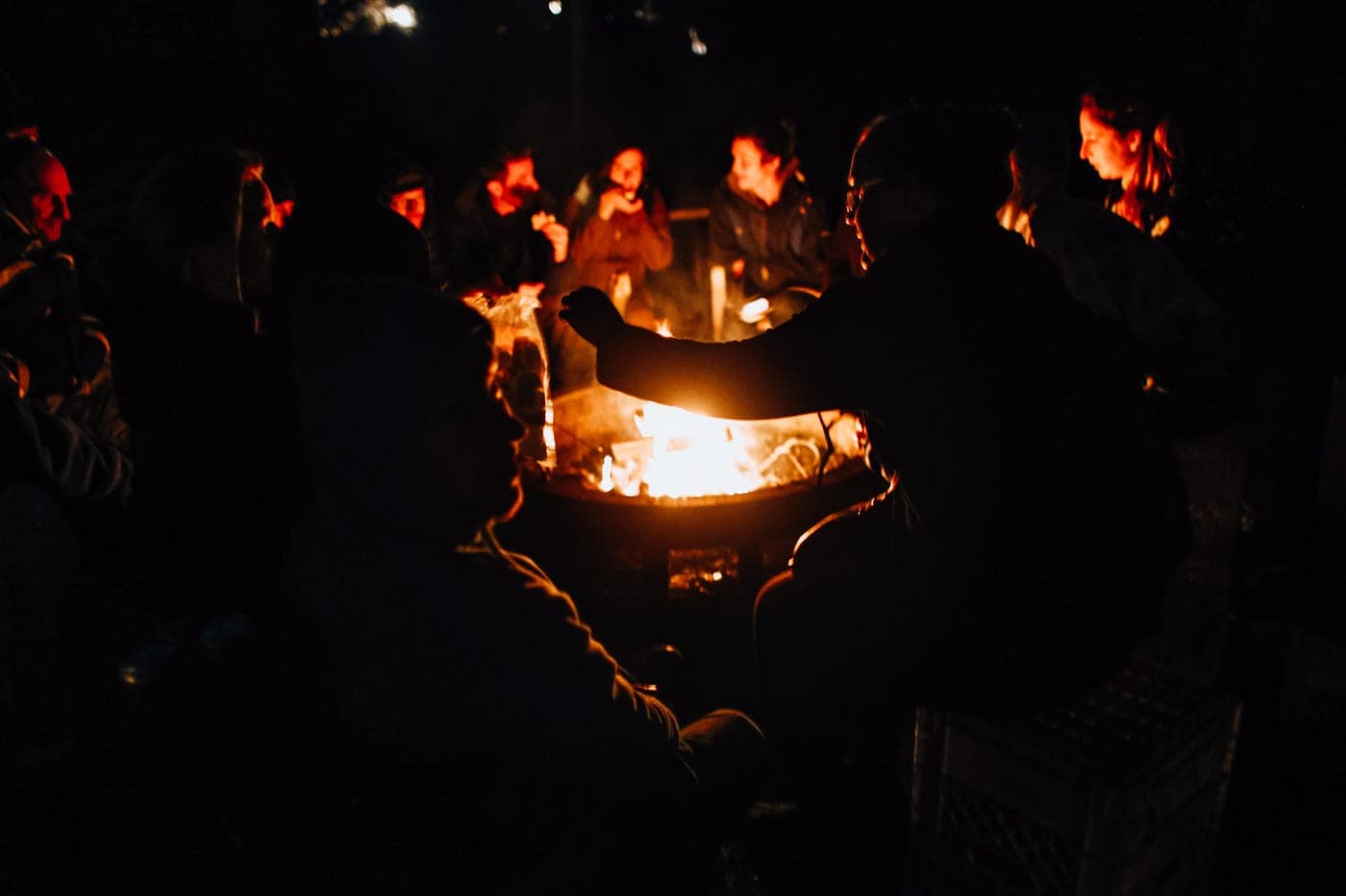 People gathered around a campfire in the evening