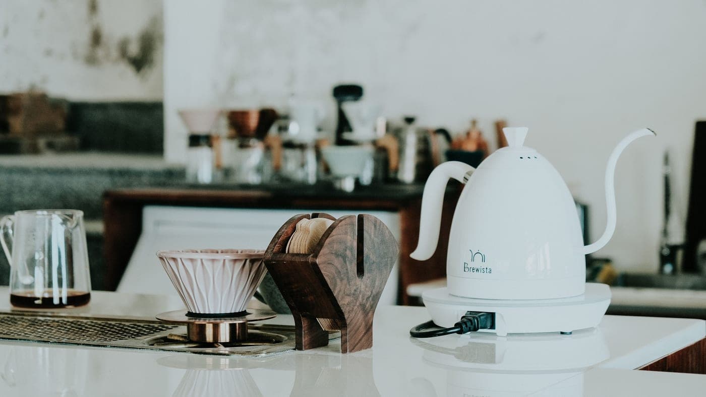 An electric kettle and coffee maker on a kitchen counter