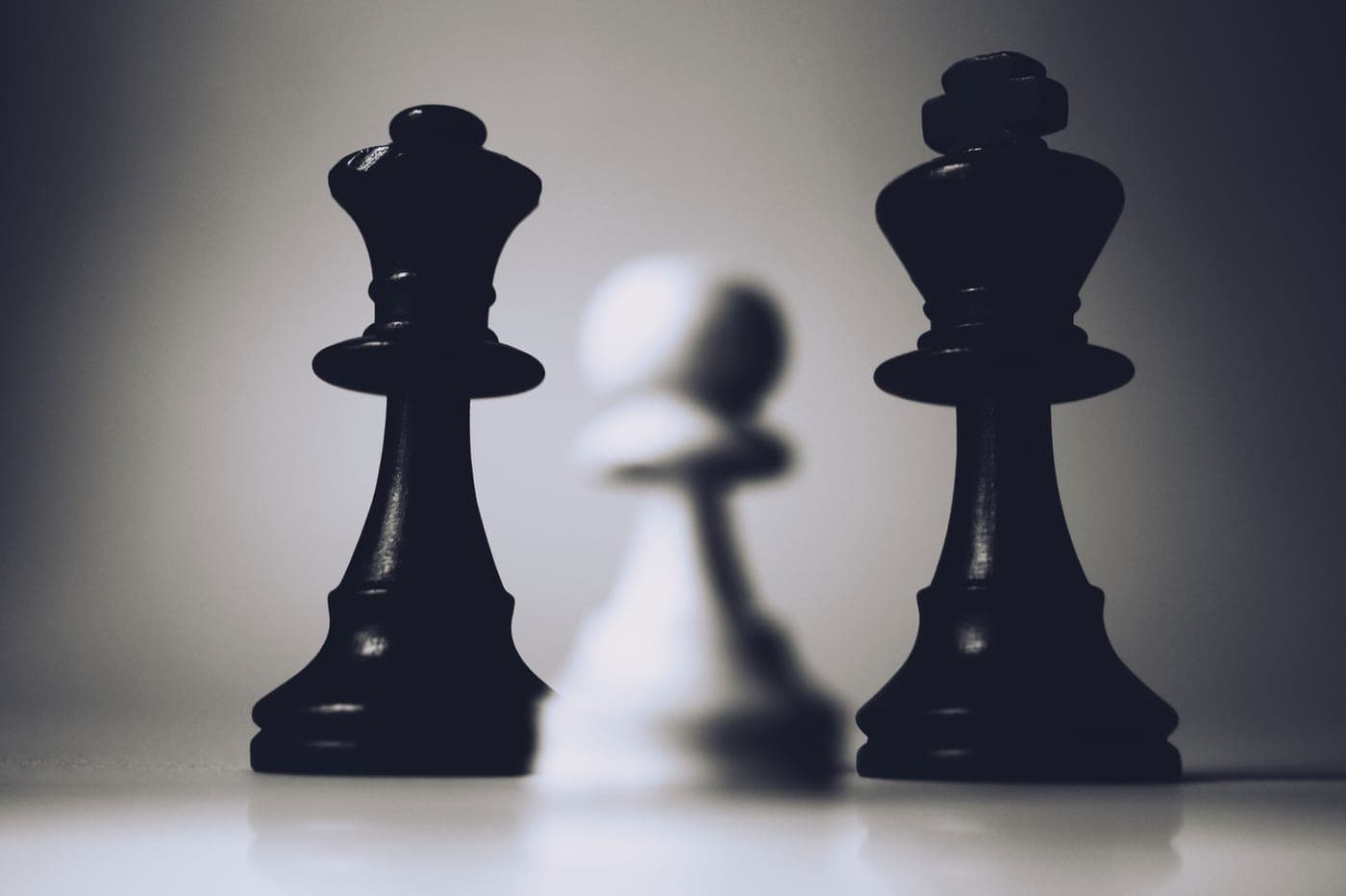 Chess pieces arranged in black and white on a board