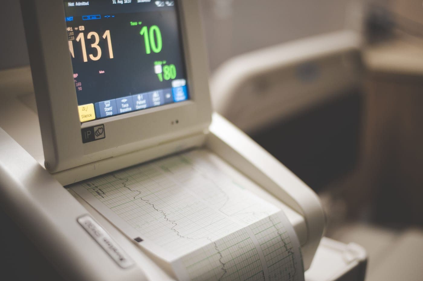 A medical device on a bedside table in a dim room