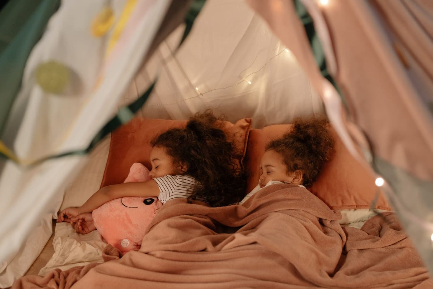 A person resting in a tent at night