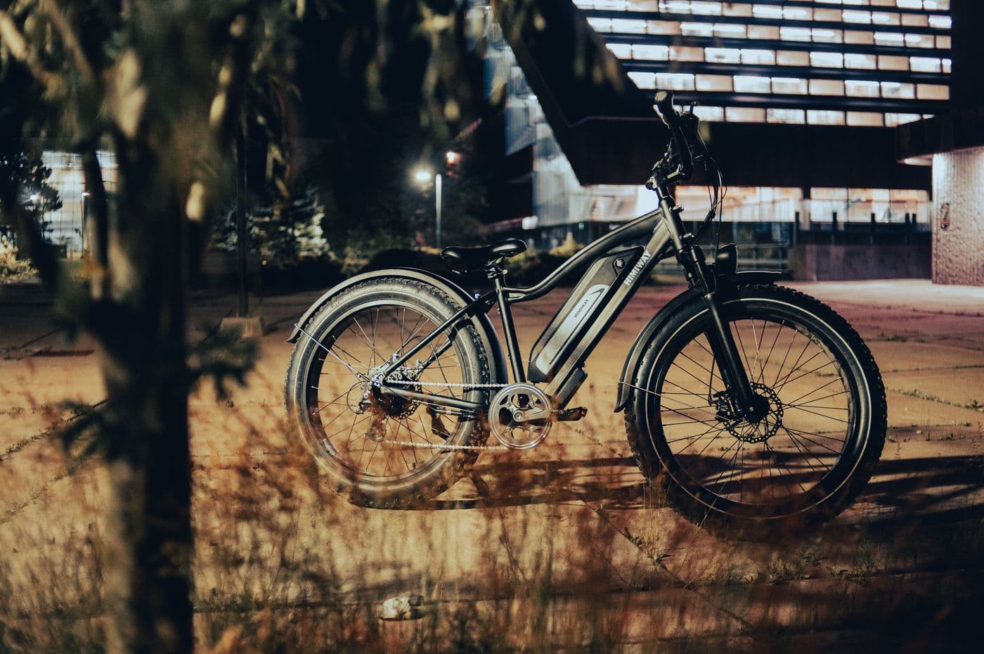 An electric bike parked on a city pavement at night