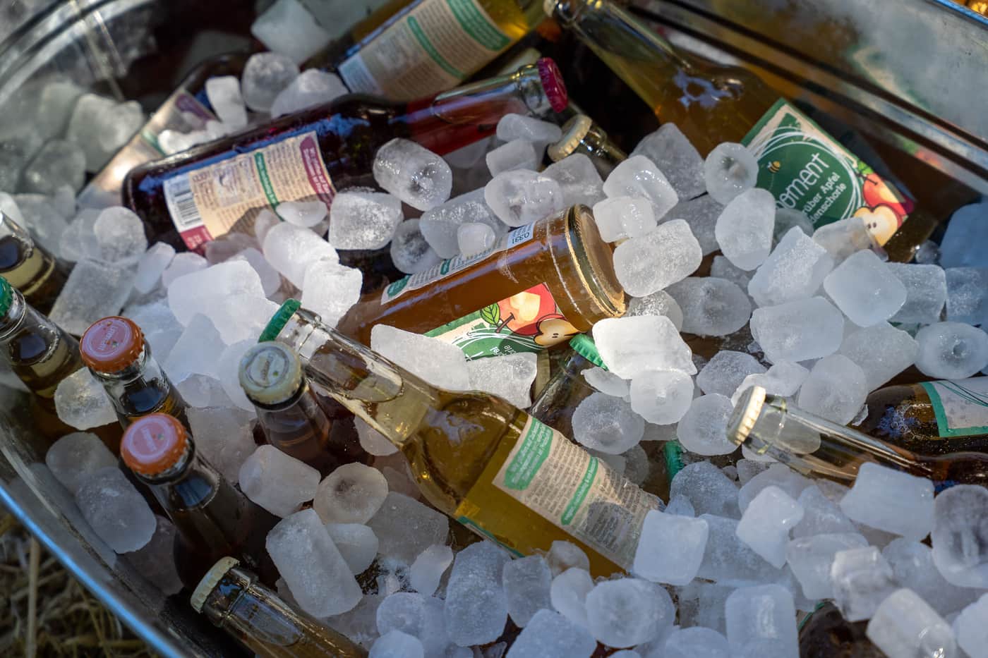 A cooler filled with drinks and ice outdoors