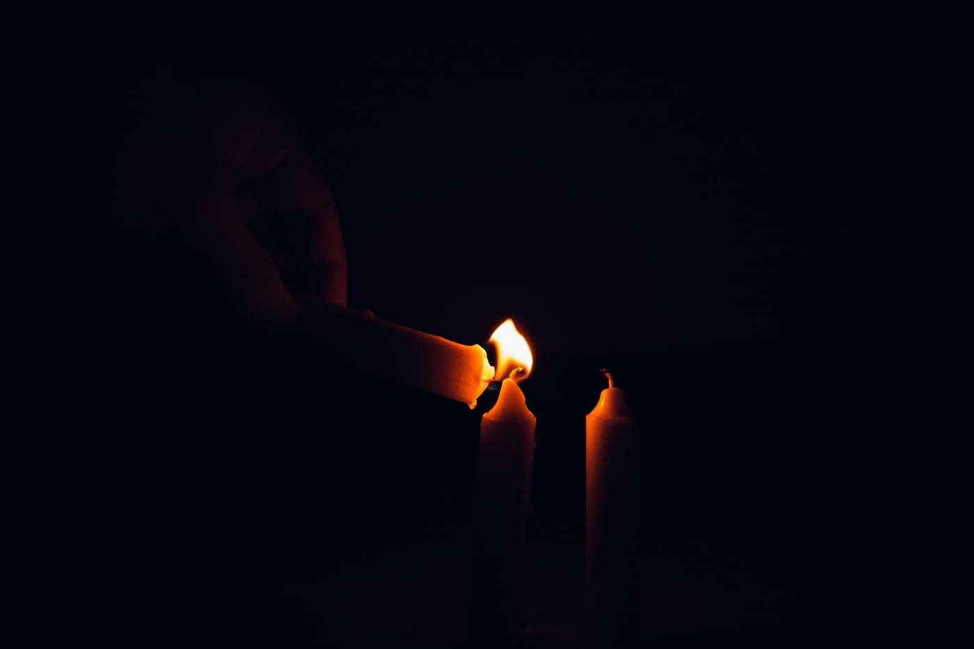 A dark kitchen lit only by a candle during a power cut