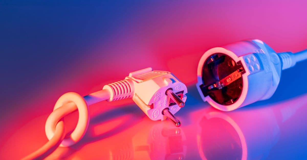 A close-up of an electrical plug and socket under bright light