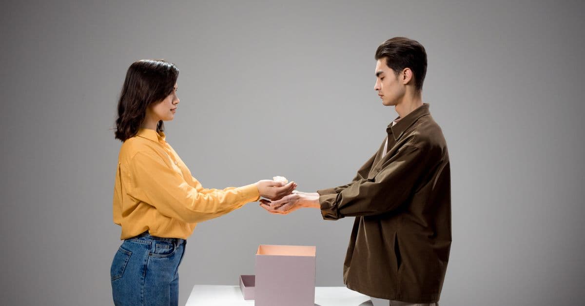 Two boxes held side by side against a plain studio background