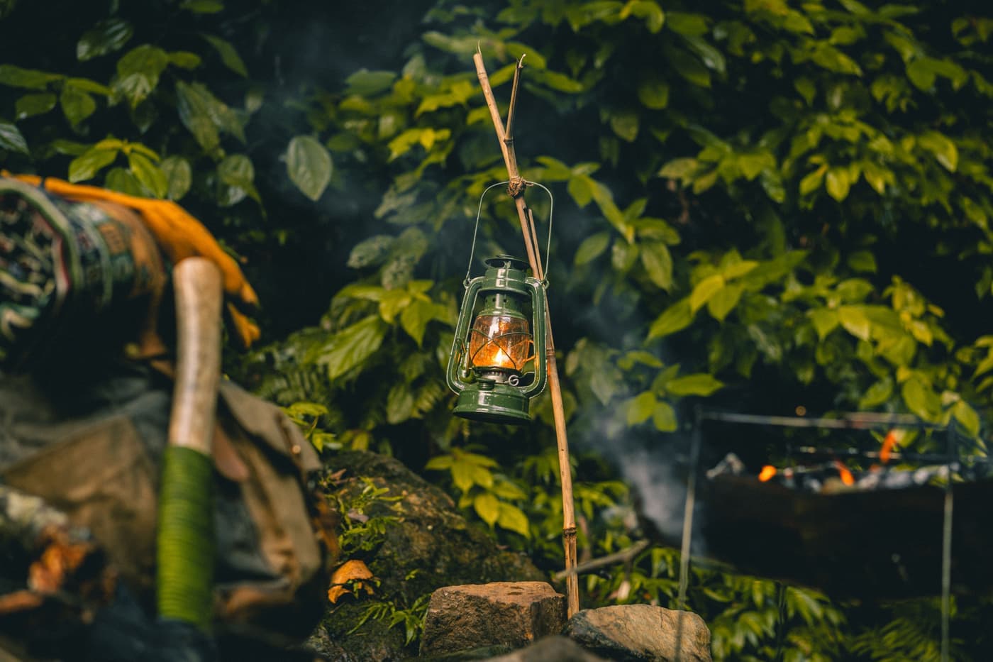 A small portable lantern lighting a dark campsite