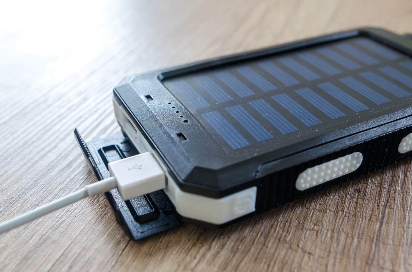 A folding portable solar panel set up on open ground